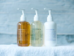 Three bottles of Provinscia products on a white towel.
