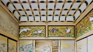 A traditional room with a ceiling featuring a geometric pattern, walls adorned with detailed murals, and a wooden floor. - Richmond Hotel Nagoya Shinkansenguchi (Nagoya)
