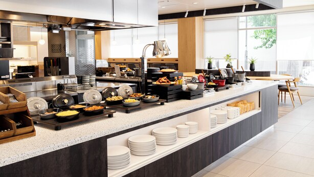 A modern kitchen with a buffet setup, including various food items and utensils. - Richmond Hotel Nagoya Shinkansenguchi (Nagoya)
