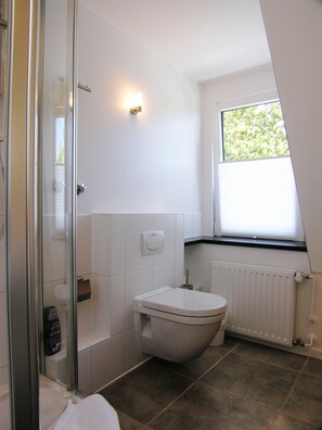 Shower, designer toiletries, hair dryer, bathrobes
