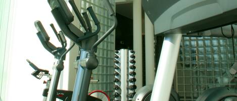 A gym with exercise equipment, including treadmills and stationary bikes.