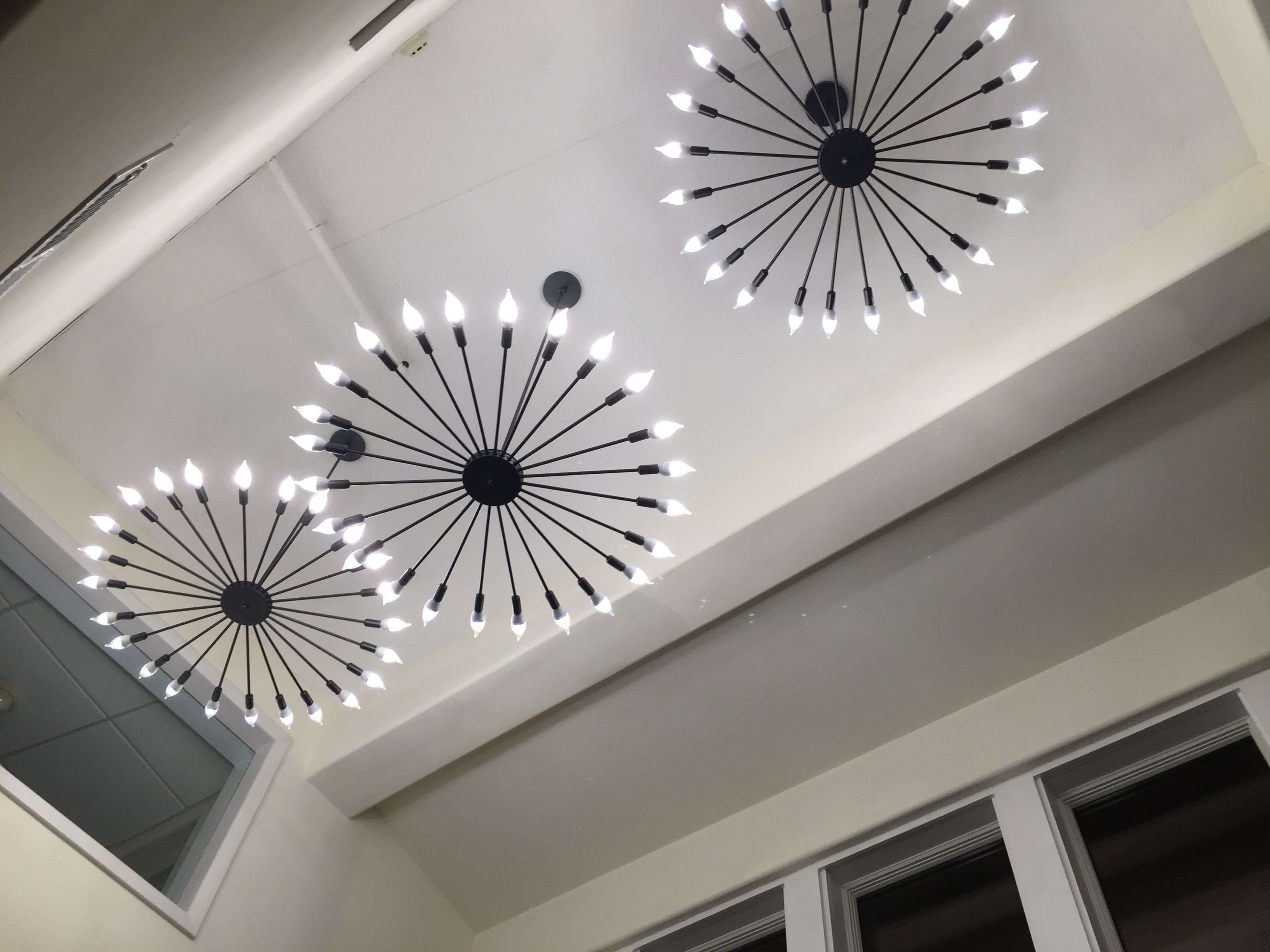 A ceiling with three modern light fixtures.