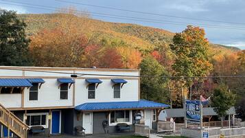 A motel with a blue roof, a front desk, and a signboard.