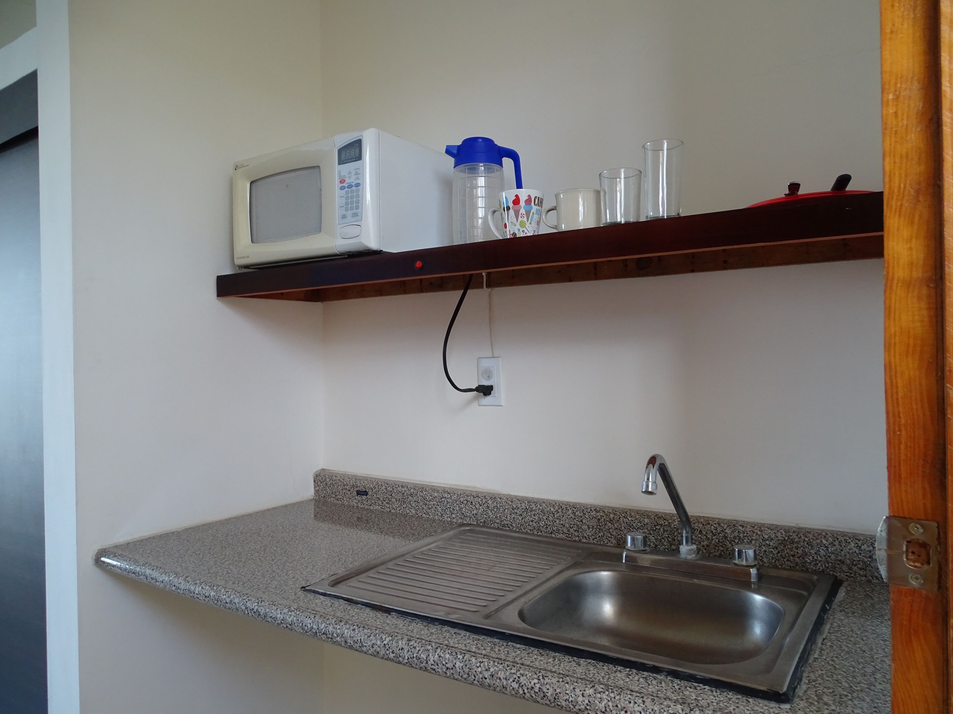 mini-fridge, microwave, electric kettle, cookware/dishes/utensils