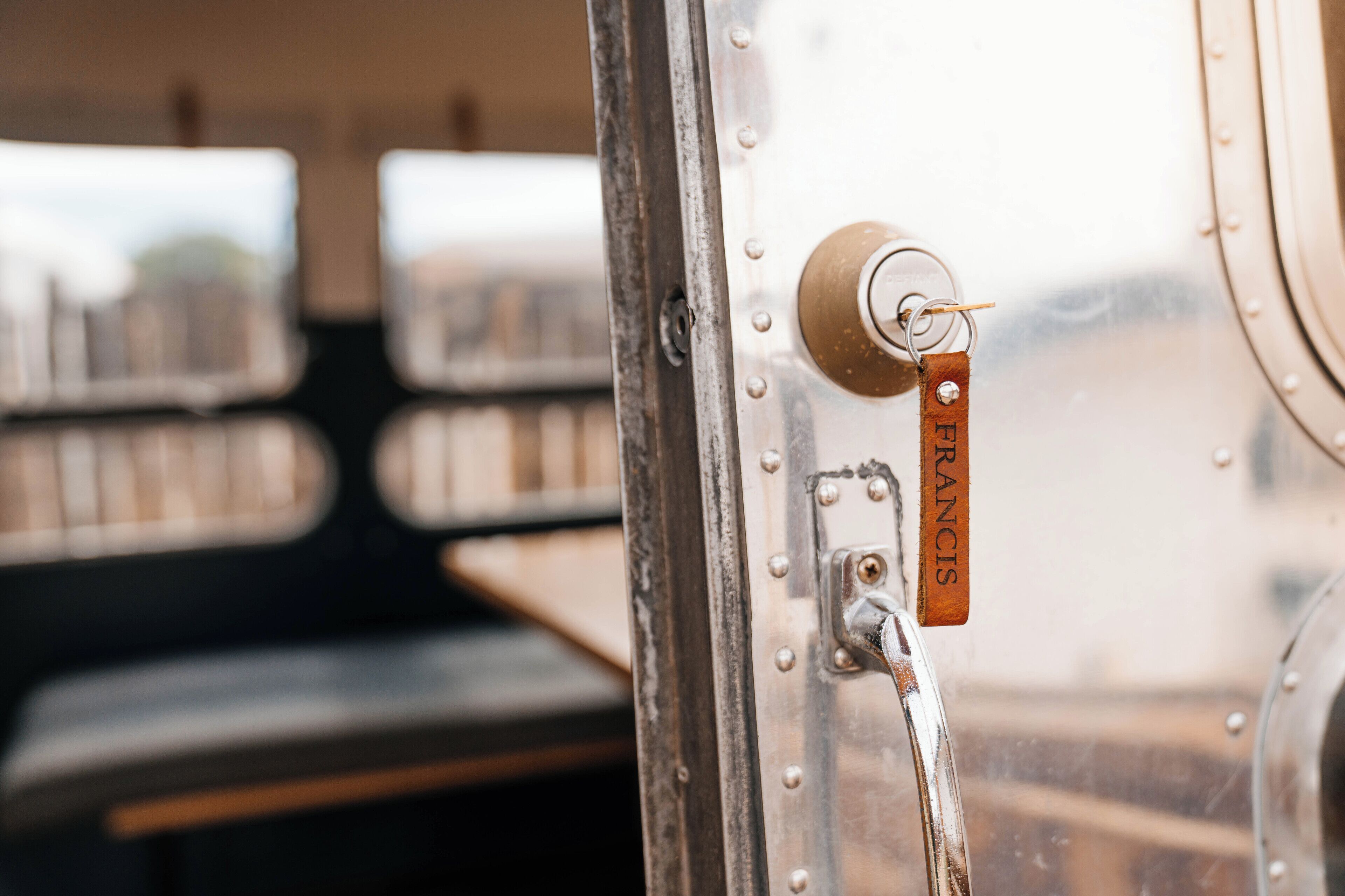 A close-up of a metal door with a keyhole and a key labeled "FRANCIS."