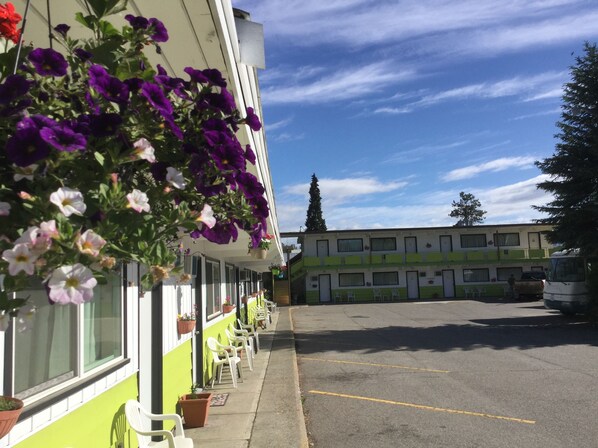 A row of single-story buildings with a parking lot in front.
