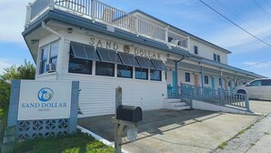 A two-story building with a sign reading "Sand Dollar Motel." - Sand Dollar Motel (Atlantic Beach)