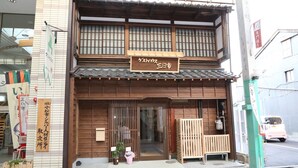 Een traditioneel Japans gebouw met een houten gevel en een bord waarop staat dat het een 'Kagetsu' gelegenheid is.