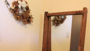 A wooden-framed mirror with a reflection of a toy block arrangement and a small dog. - Tocotoco House (Nakafurano)