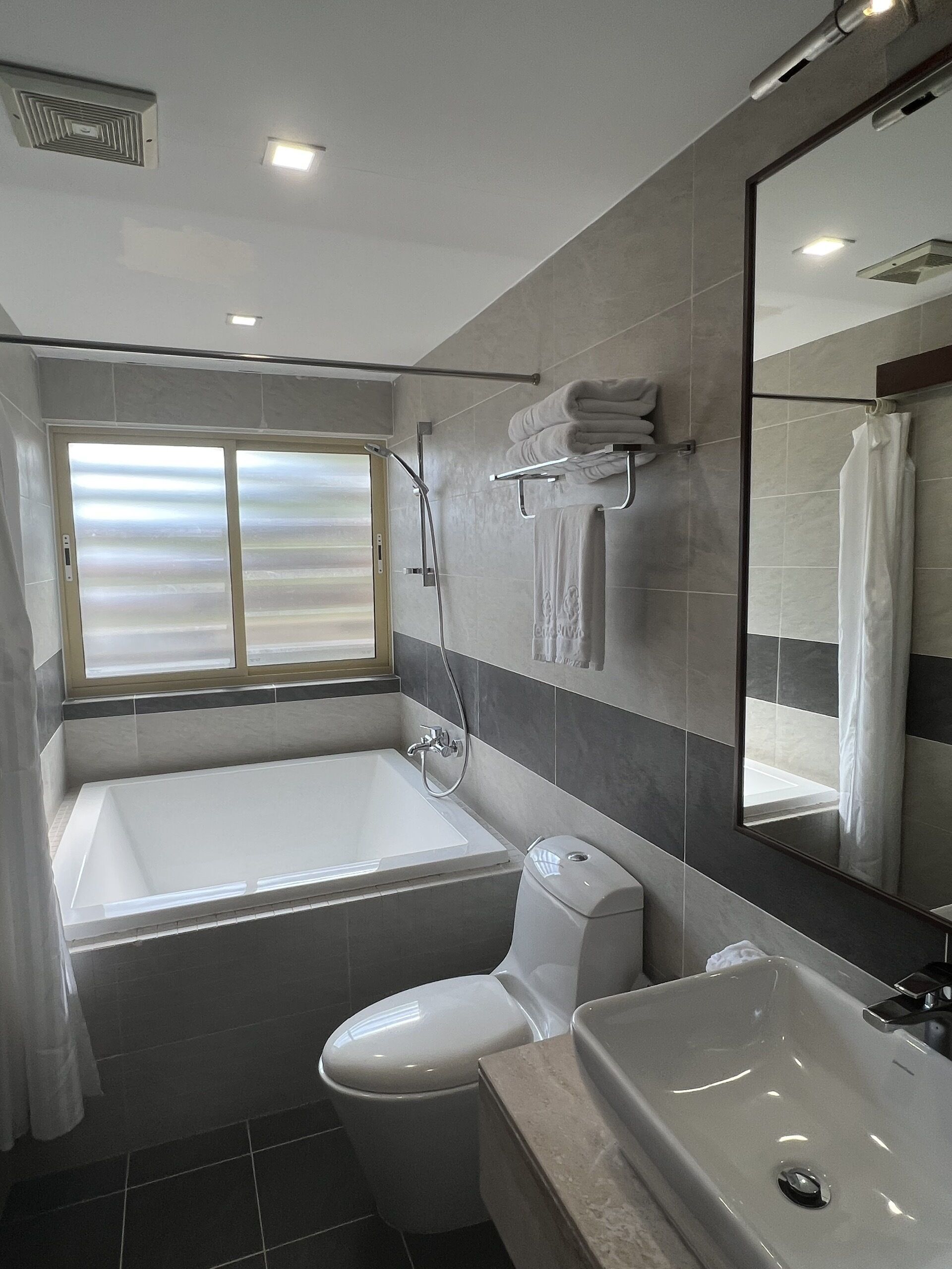 deluxe bathtub with balcony | bathroom | free toiletries, hair dryer, bathrobes, slippers