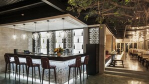 A modern bar area with a marble countertop, multiple bar stools, and hanging spherical light fixtures. - Glenwood City Resort (Ho Chi Minh City)