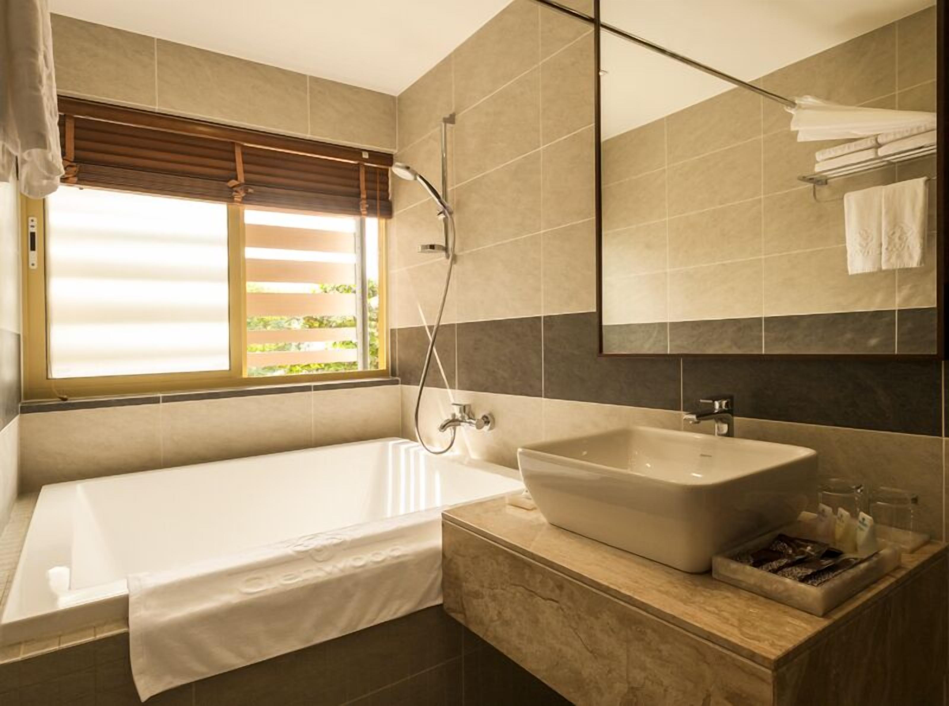 deluxe bathtub with balcony | bathroom | free toiletries, hair dryer, bathrobes, slippers
