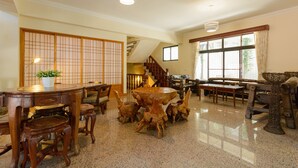 A traditional Japanese-style room with tatami flooring, a low wooden table, and a shoji screen. - Warmhouse (Taitung)