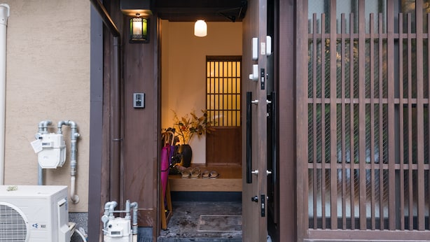 A traditional Japanese entrance with a wooden door and a sliding glass window. - Your Pavilion near Kinkakuji (Kyoto)