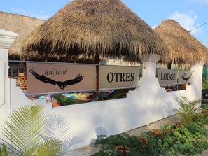 A building with a thatched roof, labeled 'OTRES' and 'LODE'. - Otres Lodge (Sihanoukville)