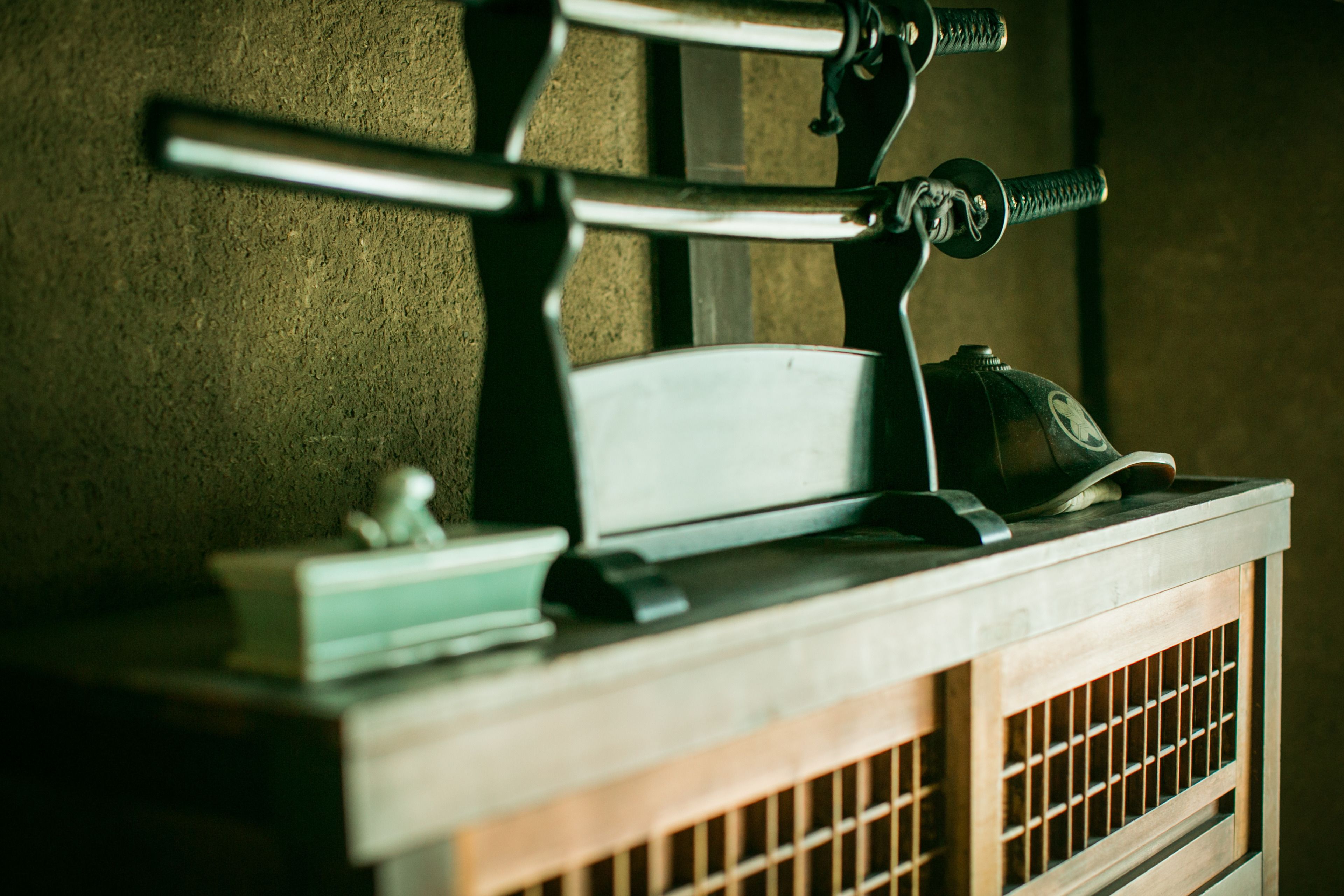 A vintage-style desk with a typewriter, a small figurine, and a book.
