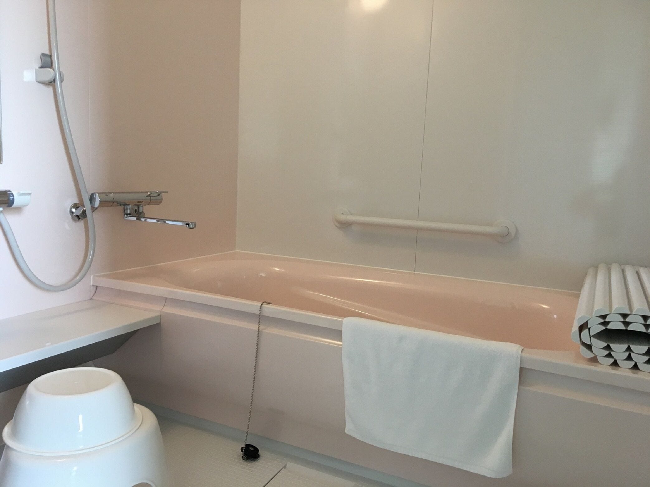 A bathroom with a bathtub, a shower, and a toilet.