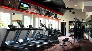 A gym with treadmills, elliptical machines, and weight equipment. - Aston Manado Hotel (Manado)