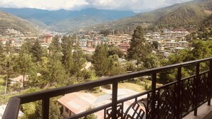 A mountainous town with buildings and greenery. - Bhutan Suites (Thimphu)