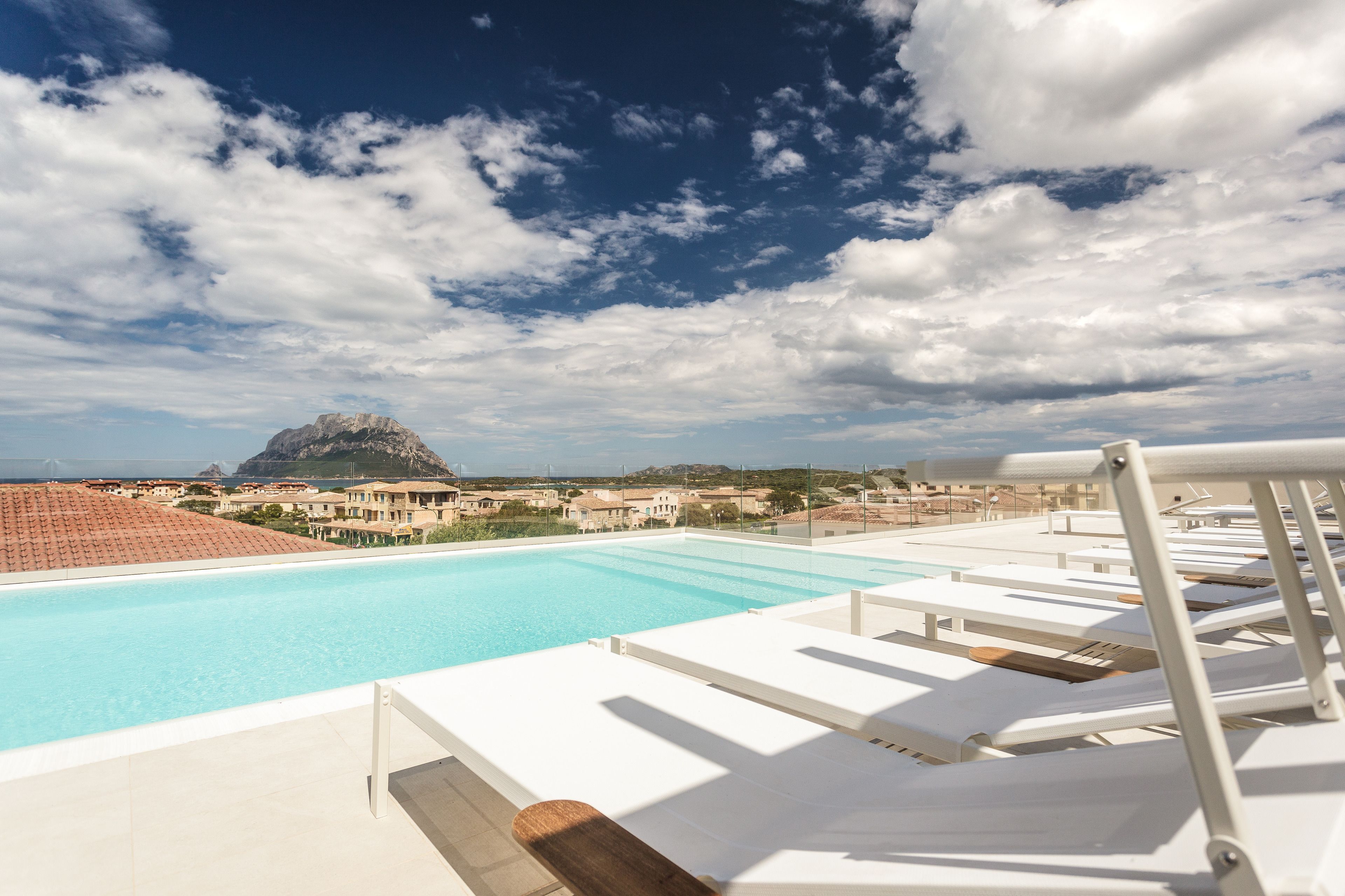 outdoor pool, a rooftop pool, pool loungers