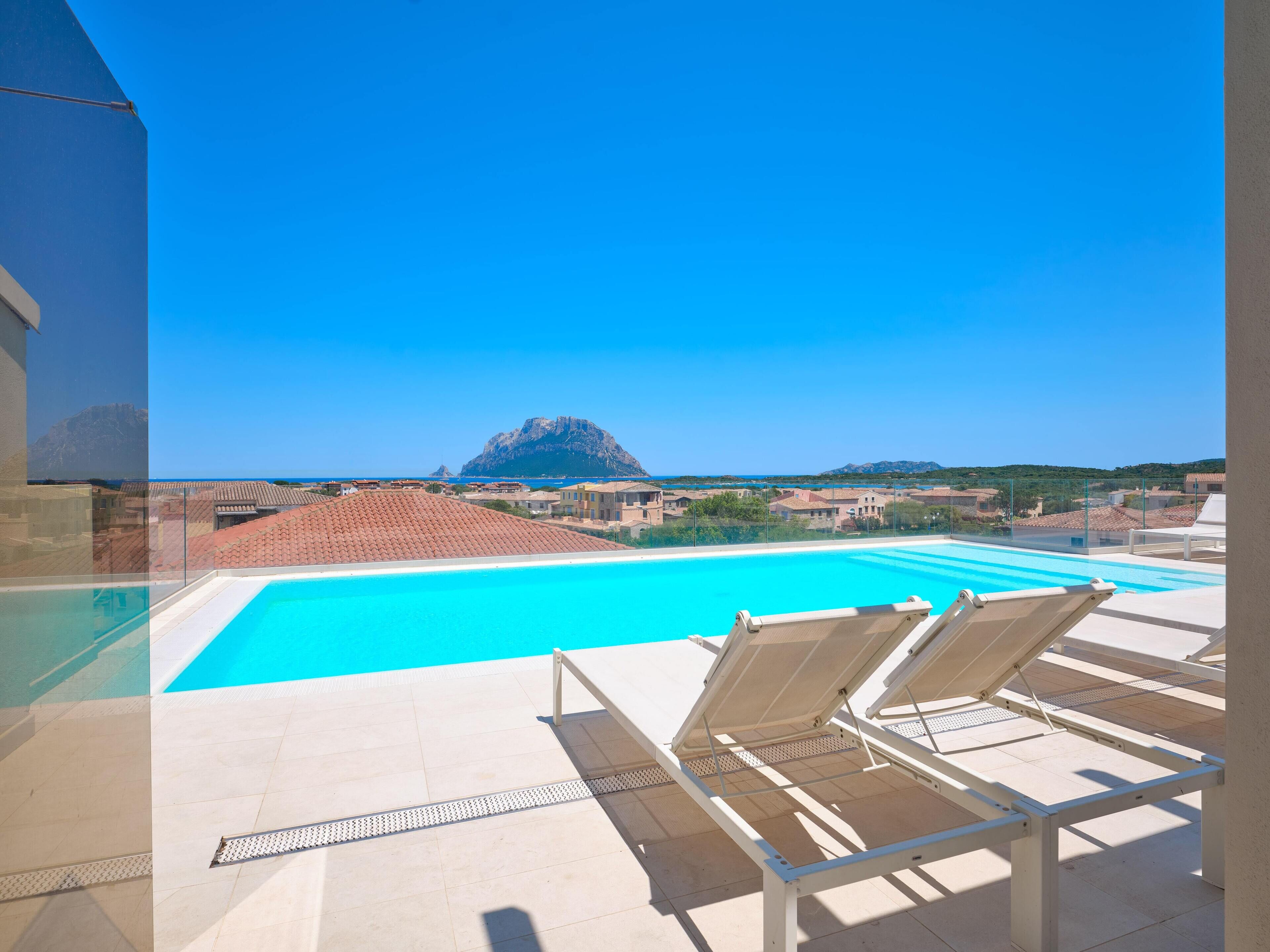 outdoor pool, a rooftop pool, pool loungers