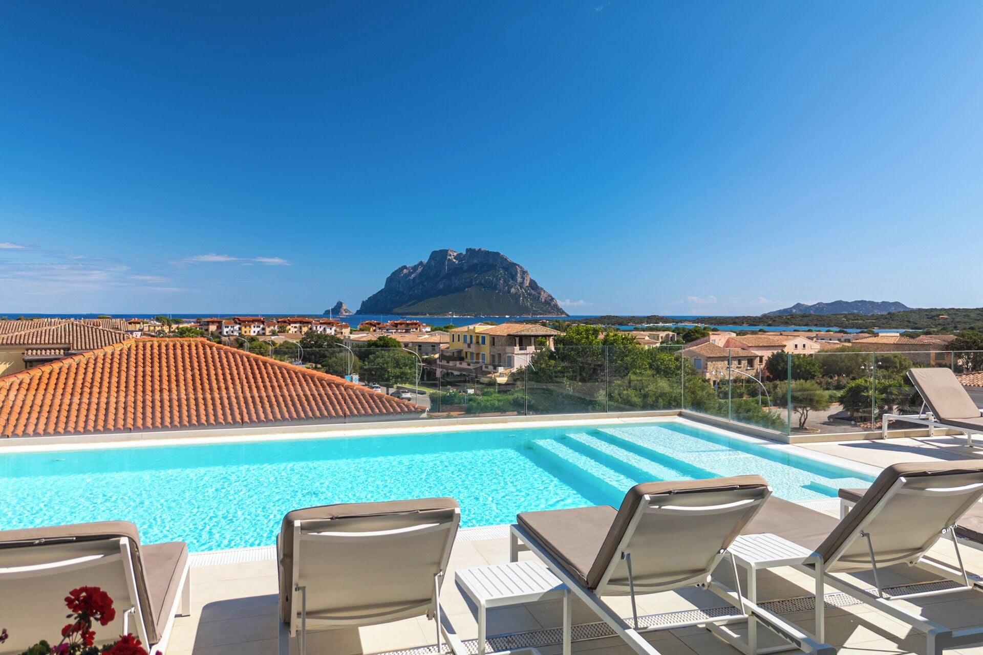 Een buitenzwembad, een zwembad op het dak, ligstoelen bij het zwembad