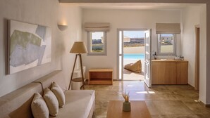 Una sala de estar moderna con un sofá, una mesa de centro y un cuadro en la pared.