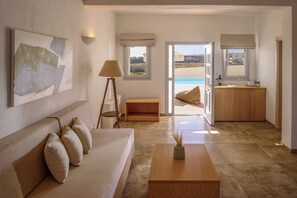 Superior Suite | Living area | 32-inch flat-screen TV with satellite channels, TV - Aliter Suites (Santorini)