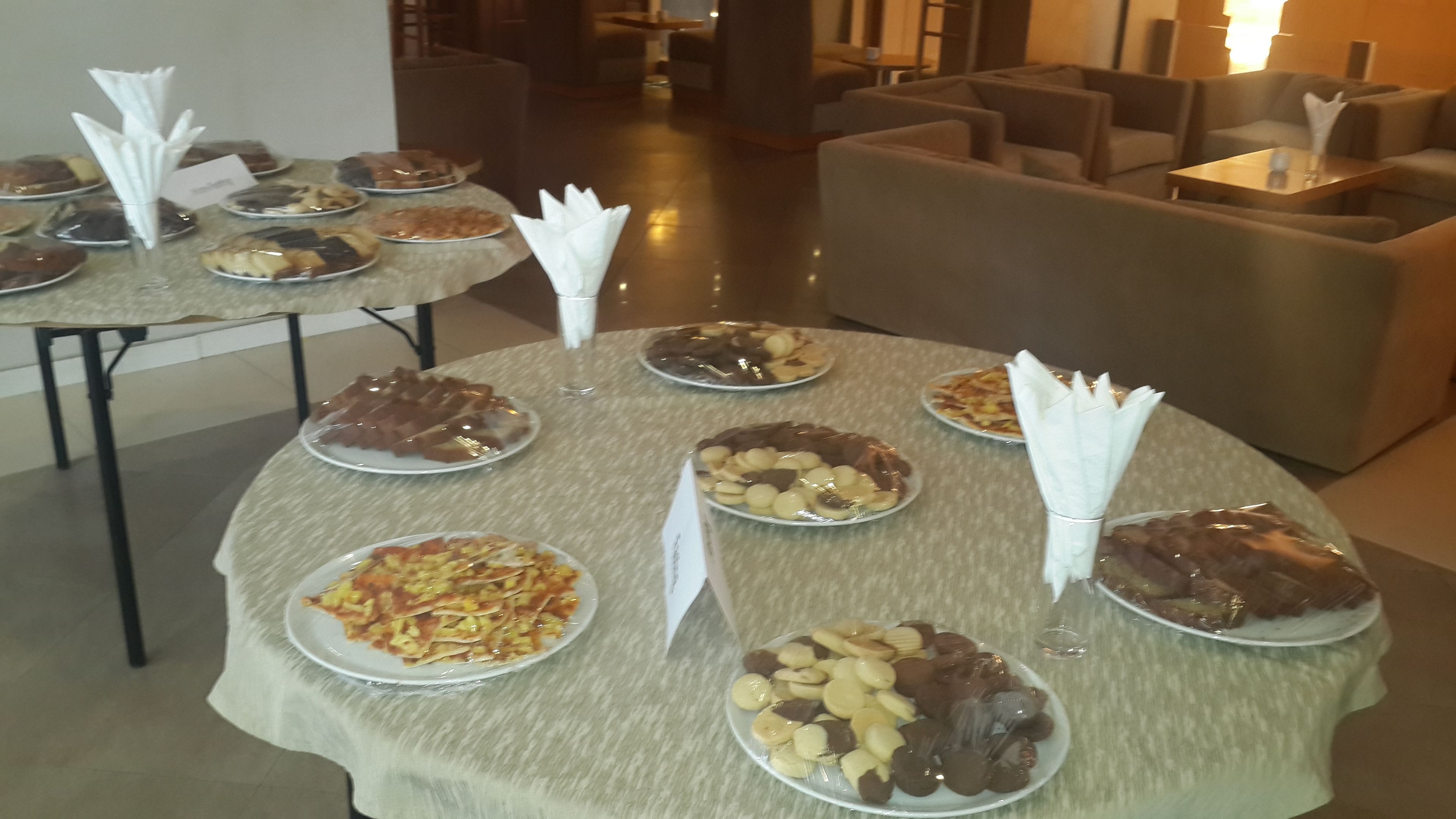 A buffet table with various dishes and napkins.