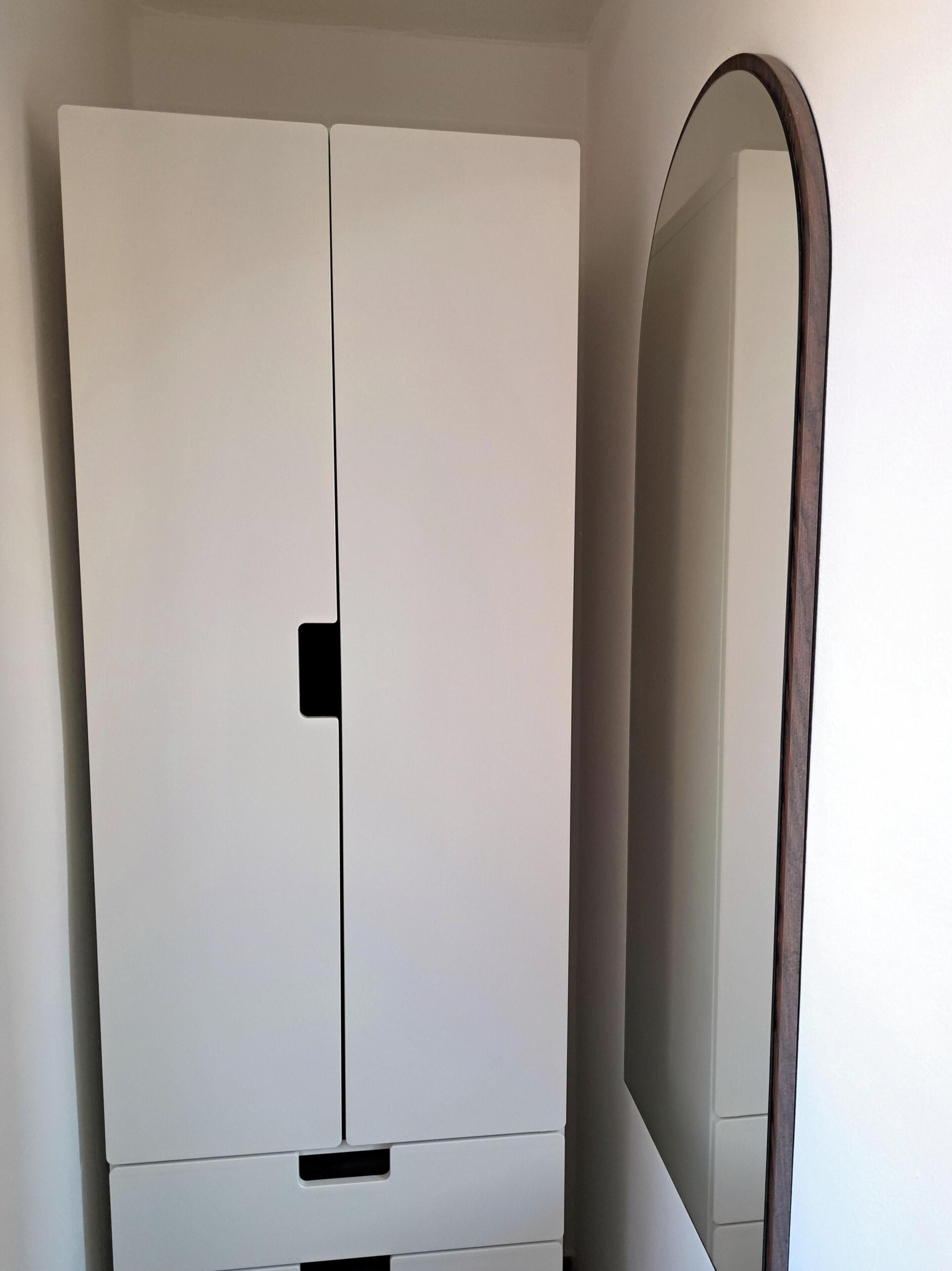 A white wardrobe with a mirror.