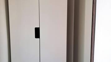 A white wardrobe with a mirror.