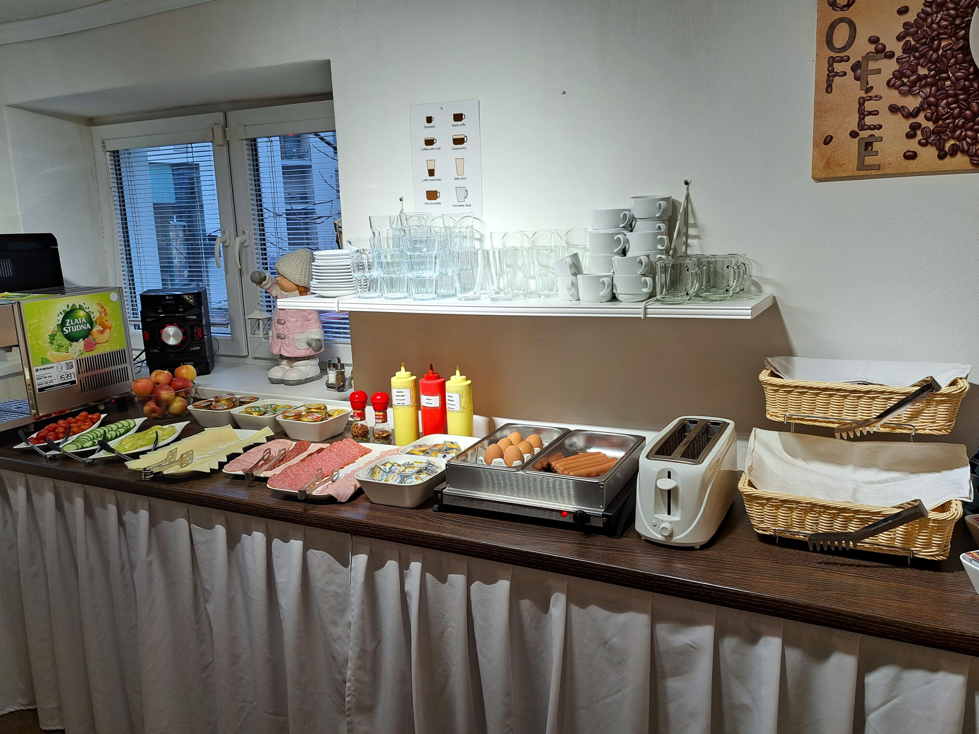 A buffet setup with various food items, condiments, and utensils.