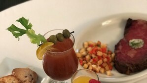 A variety of dishes including a steak, muffins, and a dessert with fruit.