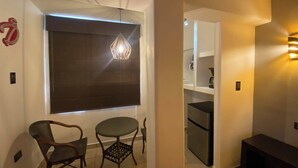 A modern kitchen with a dark backsplash, a built-in oven, and a refrigerator. - Hotel Flores (Guamuchil)