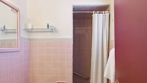 A bathroom with a toilet, sink, and shower area. - Heidelberg Motel by Capital O Bridgeport Frankenmuth I 75 (Bridgeport)