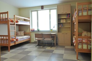 A room with bunk beds, a desk, and a chair. - University Centre (Lviv)