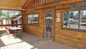 A wooden cabin with a porch, a sign reading "Chinoak," and a view of the outside. - Chinook Cabins & RV Park (South Fork)