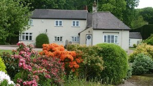 A two-story house with a garden in front. - The Coach House (Stafford)