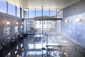 A modern indoor pool area with clear glass walls, multiple faucets, and a clean, reflective floor. - Atami Tensui (Atami)