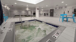 A swimming pool area with a 'NO DIVING' sign, a water slide, and blue chairs. - Staybridge Suites Denver Downtown by IHG (Denver)