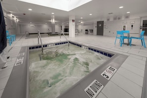 A swimming pool area with a 'NO DIVING' sign, a water slide, and blue chairs. - Staybridge Suites Denver Downtown by IHG (Denver)