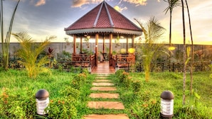 A gazebo with a tiled roof, surrounded by a garden with a stone pathway leading to it. - Ry's Lotus Resort d'Angkor (Siem Reap)