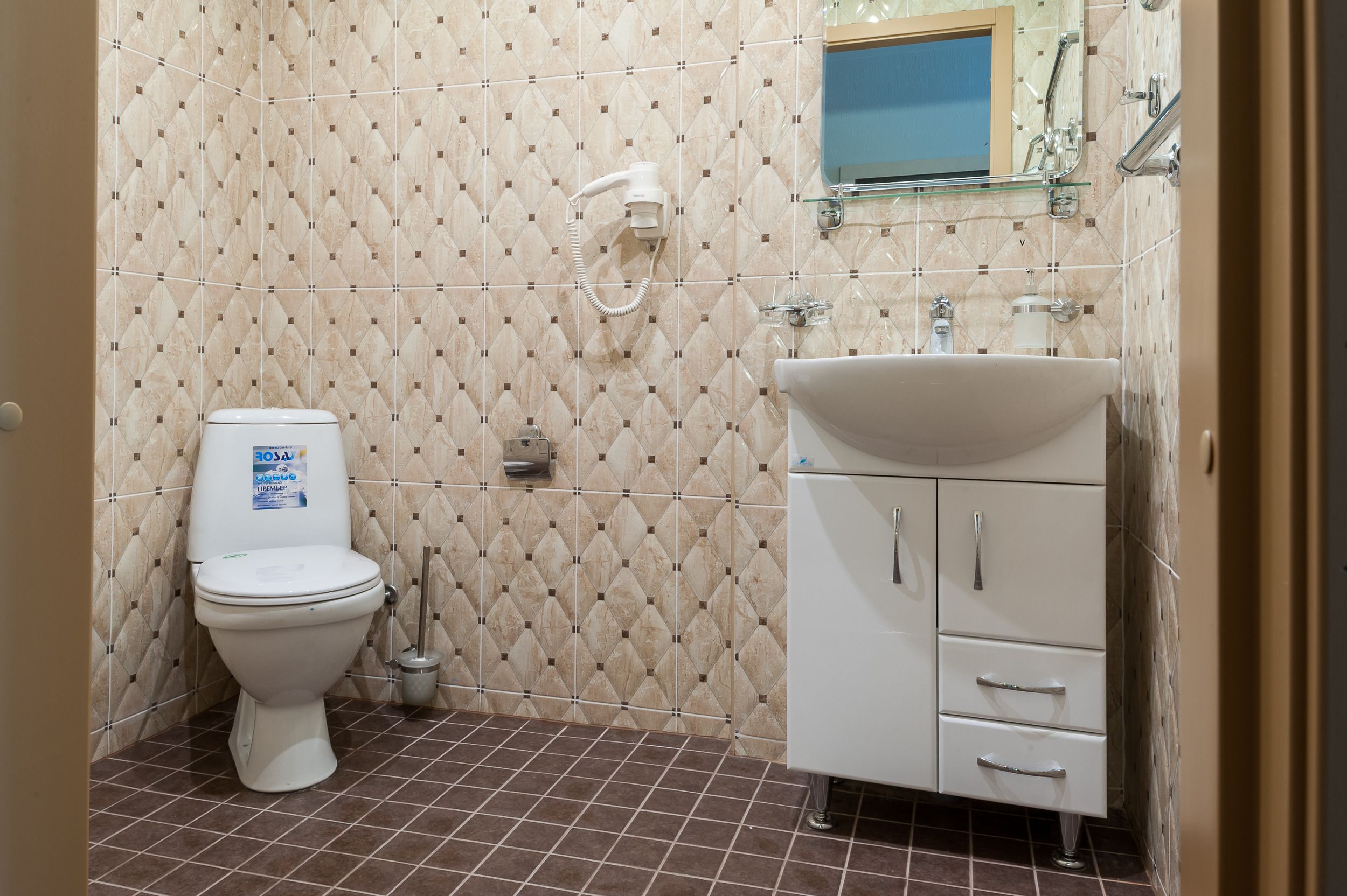 A bathroom with a toilet, a sink, and a shower.