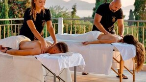 A massage therapy session on a terrace with a view of mountains and trees. - Hotel Kourkoumelata (Kefalonia)