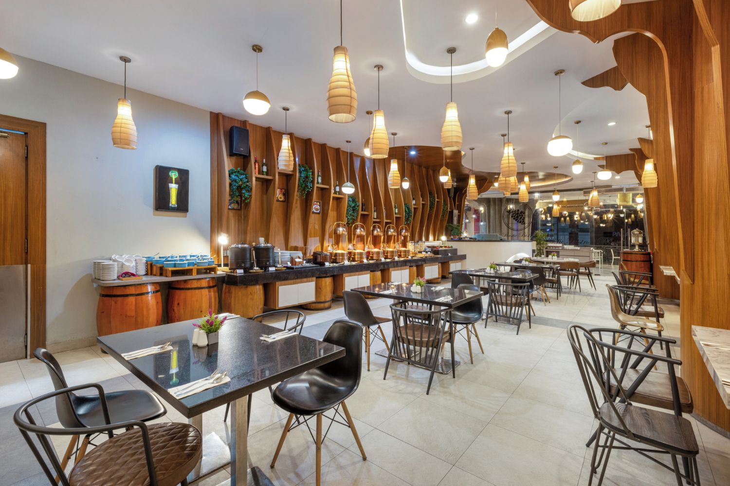 A modern restaurant interior with a bar area, dining tables, and chairs.