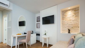 A modern room with a desk, chair, and a bed.
