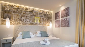 Relax in comfort with a large bed, nightstands, and a stone accent wall.