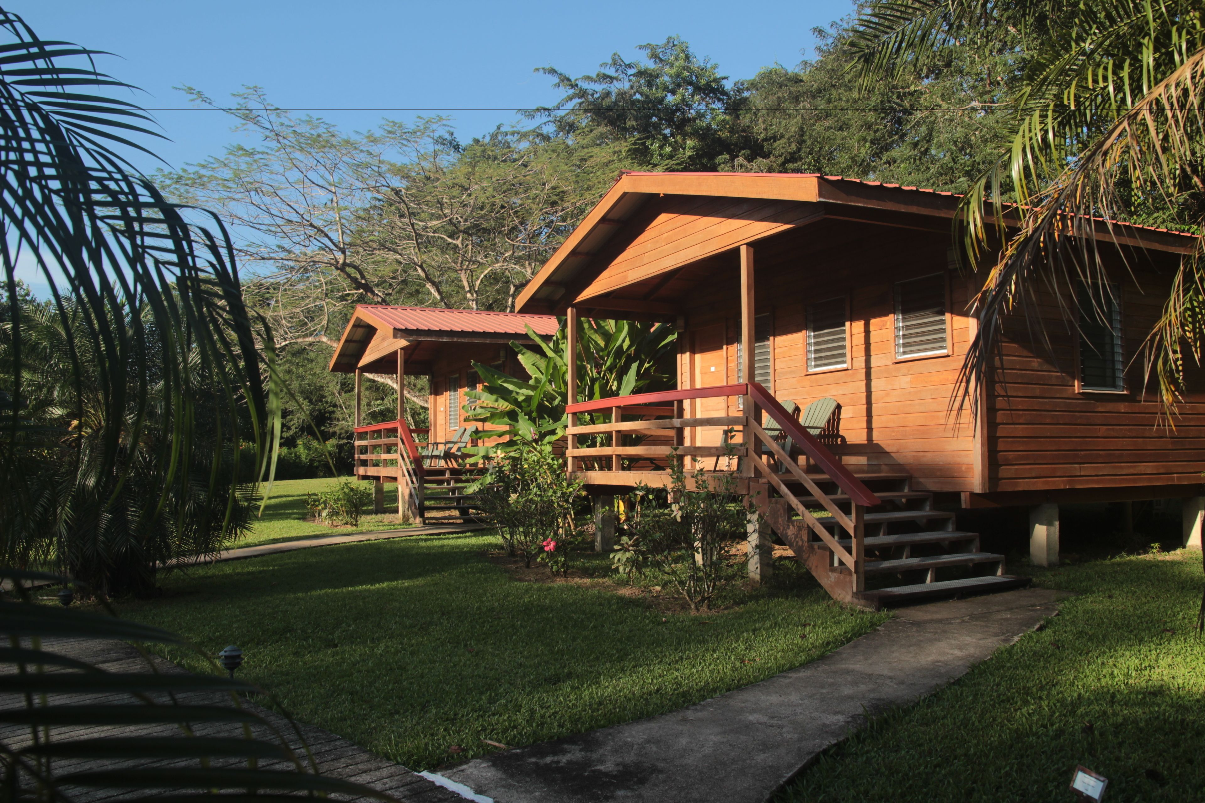 A wooden cabin with a porch and stairs leading to the entrance.