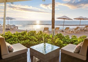 Una piscina al aire libre, sombrillas, sillones reclinables de piscina