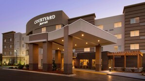 A Courtyard Marriott hotel with a covered entrance, brick facade, and multiple floors.